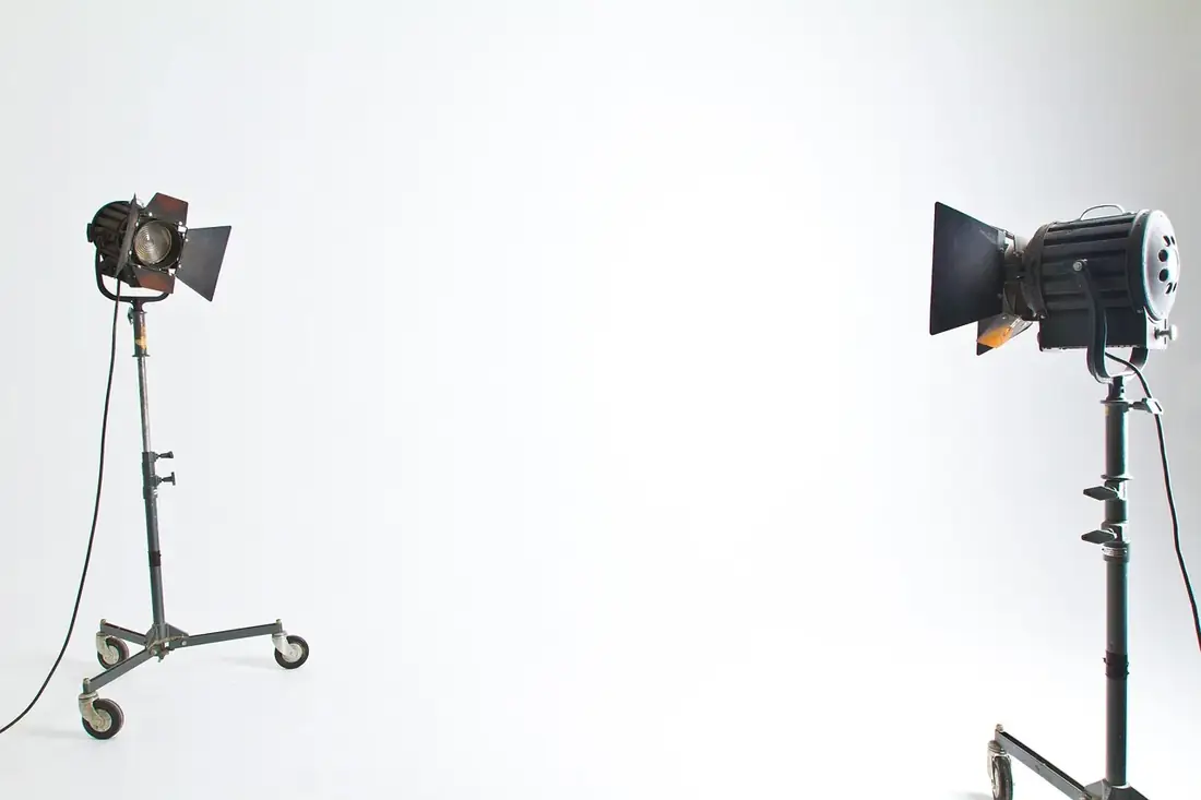 Studio lights on stands against a white backdrop