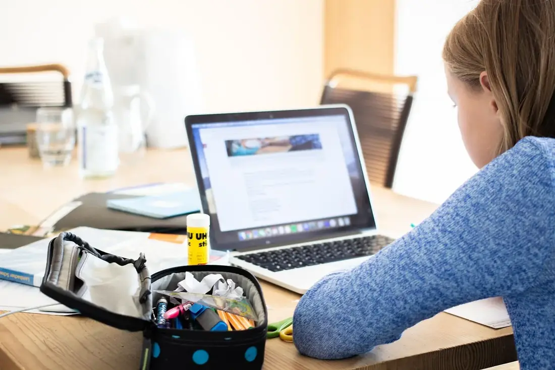 A student working on a laptop at home