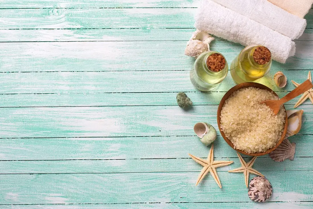 Bath salts and oils on pale teal wooden boards