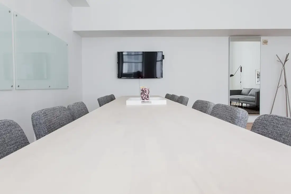 An empty boardroom with a long table