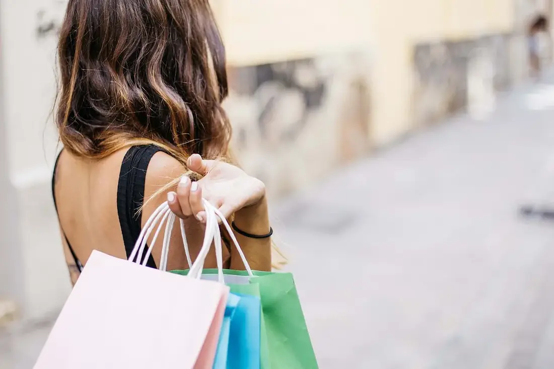 A shopper carrying paper bags